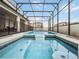 The in-ground pool, surrounded by a screened enclosure and safety fence, makes for a private and secure outdoor area at 4361 Lana Ave, Davenport, FL 33897
