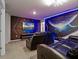 Enjoy movies in this theater room featuring comfortable seating, a large screen TV, and futuristic-themed decor at 4361 Lana Ave, Davenport, FL 33897