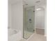 A modern bathroom showcasing a glass-enclosed shower and a separate soaking tub at 517 Delta Ave, Groveland, FL 34736