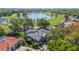 Aerial view of a single-story house next to a golf course and a lake at 703 Cricklewood Ter, Lake Mary, FL 32746
