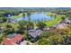 Aerial view showcasing the home, pool, lush landscaping, and surrounding golf course and lake community at 703 Cricklewood Ter, Lake Mary, FL 32746