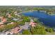 Expansive aerial view captures the waterfront properties with mature trees and surrounding landscape at 703 Cricklewood Ter, Lake Mary, FL 32746