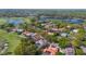 An aerial shot displaying a community nestled amongst mature trees, a golf course and a large lake at 703 Cricklewood Ter, Lake Mary, FL 32746