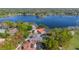 Beautiful aerial view showcasing the lake and luxurious homes with private, screened in pools at 703 Cricklewood Ter, Lake Mary, FL 32746