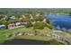 An aerial shot displaying a golf course community nestled amongst mature trees and multiple ponds at 703 Cricklewood Ter, Lake Mary, FL 32746