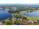Aerial view showcasing waterfront homes, lush landscaping and golf course community at 703 Cricklewood Ter, Lake Mary, FL 32746