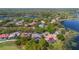 Lakefront property features screened in pool, well-manicured landscaping and mature shade trees at 703 Cricklewood Ter, Lake Mary, FL 32746