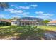 Spacious backyard with a screened-in enclosure over the patio, surrounded by well-maintained lawn and mature trees at 703 Cricklewood Ter, Lake Mary, FL 32746
