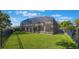Expansive backyard with screened lanai, lush lawn, and secure fencing, perfect for outdoor enjoyment at 703 Cricklewood Ter, Lake Mary, FL 32746