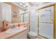 Bathroom features white walls, a toilet, a sink with counter space, and a shower with a glass door at 703 Cricklewood Ter, Lake Mary, FL 32746