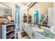 Bathroom showcasing a vanity with double sinks and tile countertops, plus a shower in a separate room at 703 Cricklewood Ter, Lake Mary, FL 32746