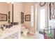 This bathroom features decorative wallpaper, a toilet, a sink, and a shower at 703 Cricklewood Ter, Lake Mary, FL 32746
