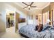 This bedroom features a walk-in closet, a ceiling fan, and a TV at 703 Cricklewood Ter, Lake Mary, FL 32746