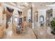 Dining area with a glass table, decorative columns, and elegant chandelier lighting at 703 Cricklewood Ter, Lake Mary, FL 32746