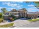 Attractive single-story home featuring lush landscaping, a brick driveway and a two-car garage at 703 Cricklewood Ter, Lake Mary, FL 32746