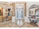 Elegant foyer with marble floors, decorative columns, and glass double doors leading into the home at 703 Cricklewood Ter, Lake Mary, FL 32746