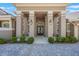 Stately home entrance featuring manicured shrubs, elegant pillars and a brick paver driveway at 703 Cricklewood Ter, Lake Mary, FL 32746