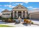 Elegant entrance showcasing pillars, a fountain, lush landscaping and a brick paver driveway at 703 Cricklewood Ter, Lake Mary, FL 32746