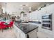 Open concept kitchen with island cooktop, stainless appliances, and eat in dining area at 703 Cricklewood Ter, Lake Mary, FL 32746