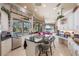 Gourmet kitchen with island cooktop, stainless appliances, and breakfast bar overlooking the water at 703 Cricklewood Ter, Lake Mary, FL 32746