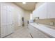 This laundry room features white cabinets, a sink, and a washer and dryer at 703 Cricklewood Ter, Lake Mary, FL 32746