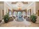 Bright formal living room with a chandelier, beautiful drapery, and views of the pool at 703 Cricklewood Ter, Lake Mary, FL 32746
