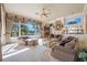 Inviting living room with large window with view, fireplace, and built-in bar area at 703 Cricklewood Ter, Lake Mary, FL 32746