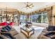 Comfortable living room with large windows offering views of the outdoor pool and golf course at 703 Cricklewood Ter, Lake Mary, FL 32746