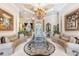 Spacious living room featuring custom ceiling, chandelier, and elegant furnishings at 703 Cricklewood Ter, Lake Mary, FL 32746