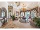 Open-concept living area with a large window overlooking the pool and landscaped backyard at 703 Cricklewood Ter, Lake Mary, FL 32746