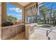 Covered outdoor kitchen area with bar, cabinets, sink, grill, and view of pool at 703 Cricklewood Ter, Lake Mary, FL 32746