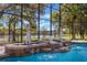 Screened in pool featuring fountains, rock features and lovely statues, a luxurious place to relax and enjoy the outdoors at 703 Cricklewood Ter, Lake Mary, FL 32746