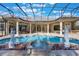 A luxurious screened-in pool area with fountains, statues, and plenty of space for entertaining and lounging at 703 Cricklewood Ter, Lake Mary, FL 32746