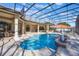 Screened-in pool area with statues, travertine pavers, columns, and outdoor seating for luxury enjoyment at 703 Cricklewood Ter, Lake Mary, FL 32746