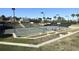 Well-maintained tennis court with stadium seating, professional lighting, and meticulously landscaped surroundings at 703 Cricklewood Ter, Lake Mary, FL 32746