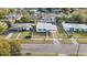 Aerial view of a well-maintained home with a neat lawn, surrounded by mature trees in a quiet neighborhood at 7108 Stockholm Way, Orlando, FL 32822