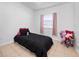 This bedroom is cozy with soft tile floors, black bedding and pink curtains at 7108 Stockholm Way, Orlando, FL 32822