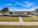 Inviting single-story home featuring a green lawn and a covered carport at 7108 Stockholm Way, Orlando, FL 32822