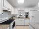 Bright kitchen featuring white cabinets, granite countertops, and modern appliances at 7108 Stockholm Way, Orlando, FL 32822