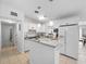 Well-lit kitchen with white cabinets, granite countertops, and stainless appliances at 7108 Stockholm Way, Orlando, FL 32822