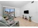 Inviting living room showcasing tile flooring, neutral walls, and comfortable seating near a bright window at 7108 Stockholm Way, Orlando, FL 32822