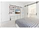 Bedroom with a large TV, display shelving, sliding barn doors to ensuite bathroom, and soft carpet flooring at 8006 Hoylake Dr, Orlando, FL 32832