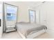 Bedroom featuring a minimalist design with soft neutral colors, carpet flooring, and large bright windows at 8006 Hoylake Dr, Orlando, FL 32832