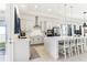 Open kitchen with stainless appliances, stone countertops, a central island with seating, and access to the backyard at 8006 Hoylake Dr, Orlando, FL 32832