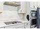 Close up of the kitchen featuring stainless steel appliances and sleek countertops at 8006 Hoylake Dr, Orlando, FL 32832