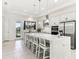Bright kitchen featuring stainless steel appliances, quartz countertops, and a large central island with seating at 8006 Hoylake Dr, Orlando, FL 32832