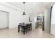 Open concept kitchen and dining area with modern lighting, tile floors, and granite countertops at 8006 Hoylake Dr, Orlando, FL 32832