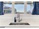 Modern kitchen sink with a stainless steel faucet and view of the surrounding neighborhood at 8006 Hoylake Dr, Orlando, FL 32832