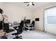 Bright office with ceiling fan, multiple computer monitors, and white trim at 8006 Hoylake Dr, Orlando, FL 32832