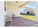 Cozy covered patio with brick flooring, comfortable seating, and view of the backyard at 8006 Hoylake Dr, Orlando, FL 32832